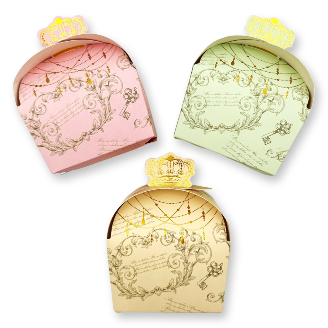A set of three paper gift boxes with a princess carrier design, in pastel pink, beige, and yellow colors, each adorned with intricate golden patterns.