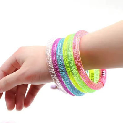 Hand wearing colorful textured bracelets on a white background