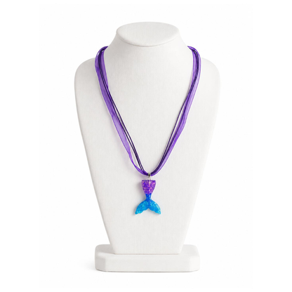 Purple necklace with a blue mermaid tail pendant on a white mannequin bust.