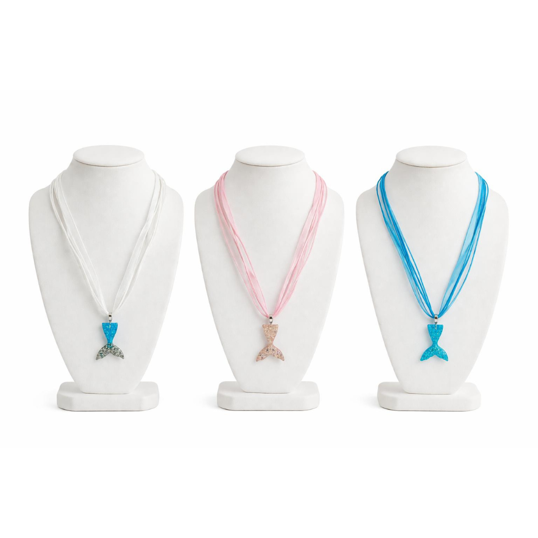 Three necklaces on mannequin heads with different colored ribbons and pendants on a white background