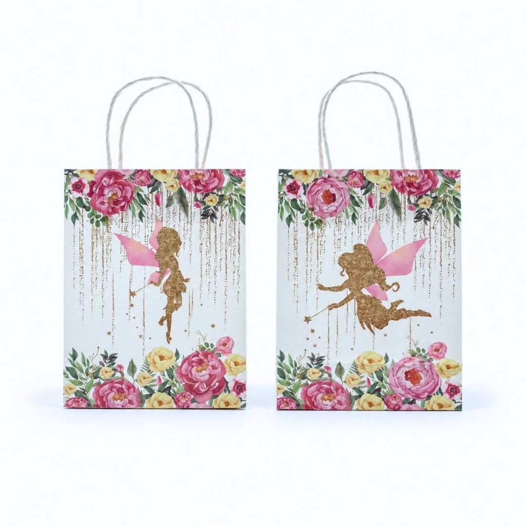 Two matching gift bags with rope handles, decorated with a colorful floral border and a gold fairy illustration on a light pastel background, shown on a white studio background.