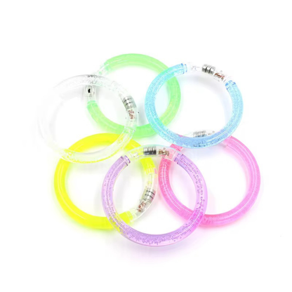 Set of colorful glowing bracelets on a white background
