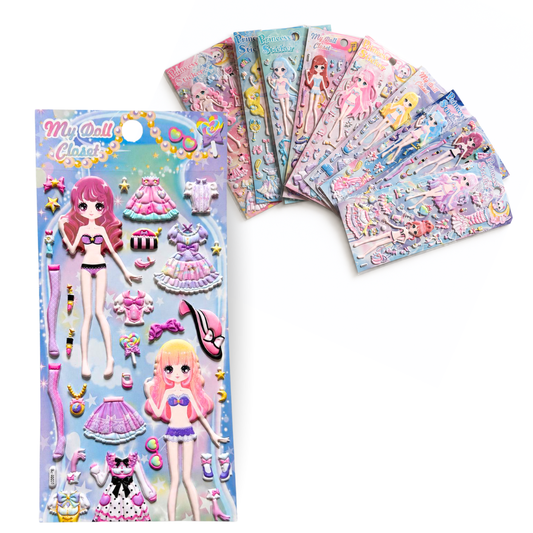 A children's sticker/card set featuring anime-style doll characters and colorful outfit accessories, shown with one full package and several matching sheets fanned out behind it on a white background.