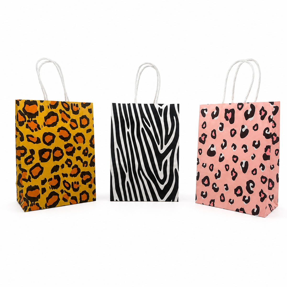 Three small paper gift bags with white twisted handles, shown side by side on a white background. The left bag has a yellow, black, and orange leopard print.