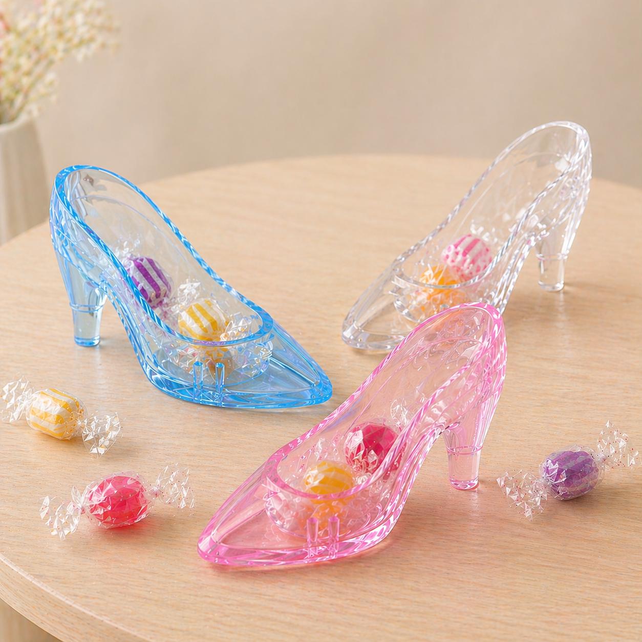 Clear glass slippers with colorful candies on a wooden surface