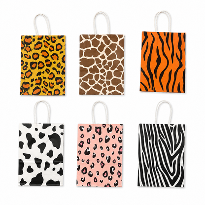 Six paper party bags arranged in a 2x3 grid on a white background, each featuring a different animal print pattern: leopard, giraffe, tiger, cow, cheetah, and zebra.