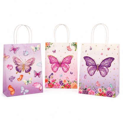 Three decorative paper gift bags with white rope handles, decorated with colorful butterfly and floral prints in pink, purple, and peach tones, set against a plain white background.